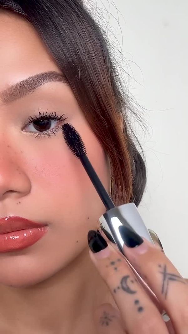 Kaybe applying mascara, close-up