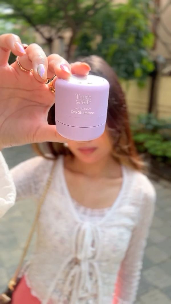 Kaybe holding up a skincare jar